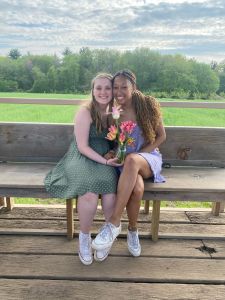 A picture of best friends Haley and Kiley holding flowers.